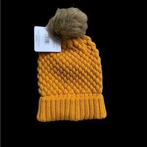 yellow knit hat with pom